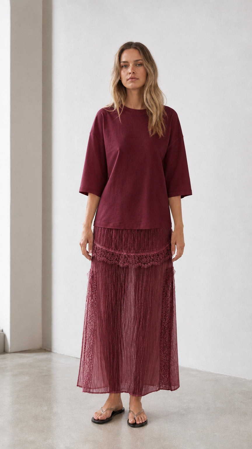 Front view of woman wearing burgundy relaxed tee and matching skirt set