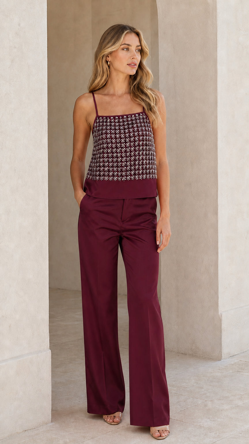 Woman wearing burgundy sequined cami and wide-leg pant set