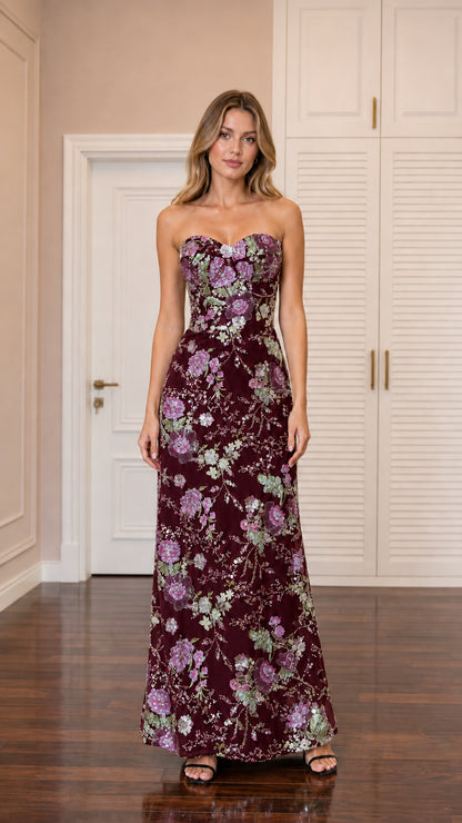 Front view of model wearing burgundy sequin embroidered strapless column gown