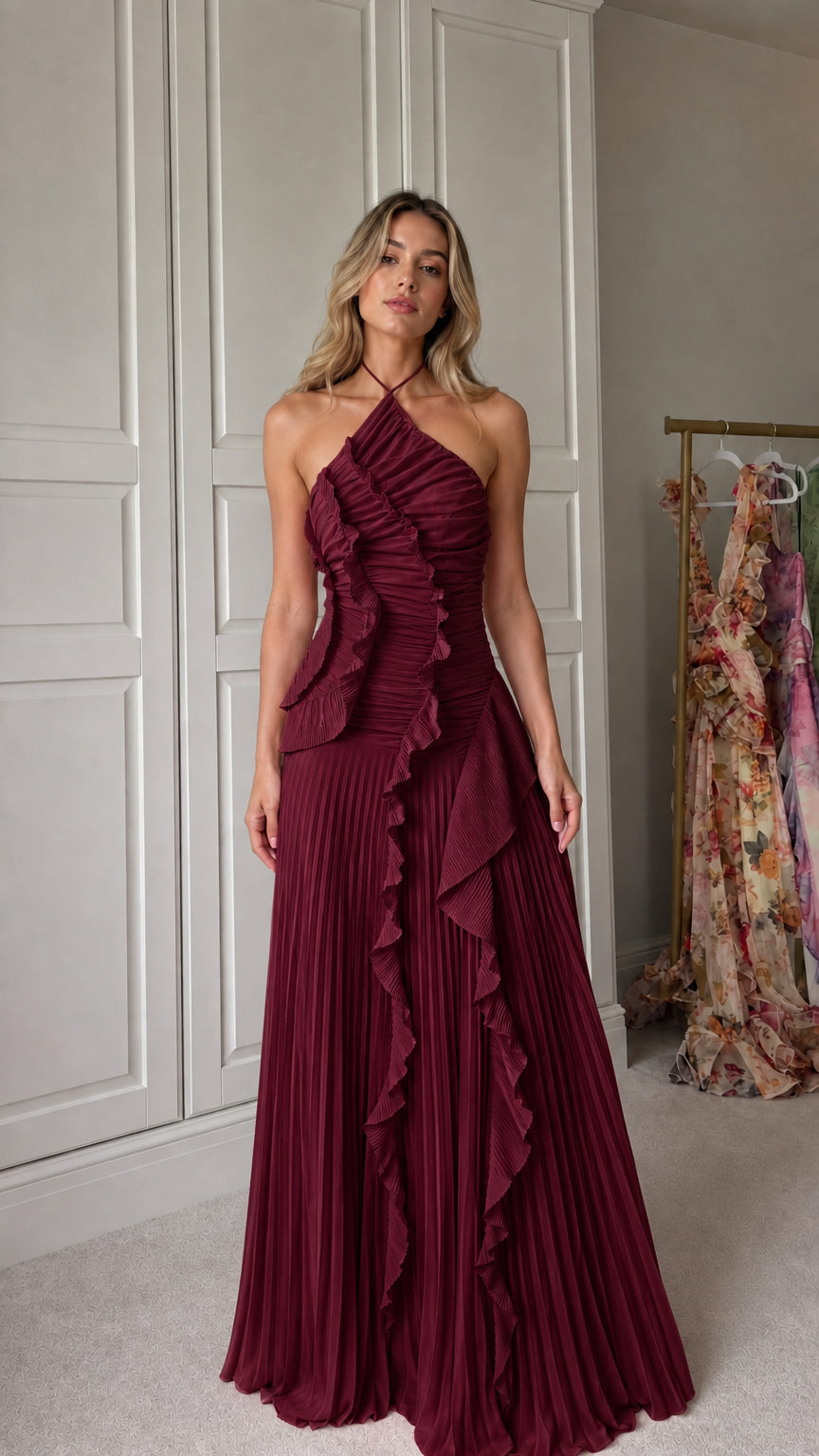 Front view of model wearing burgundy halter neck pleated ruffle maxi dress