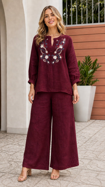Woman wearing burgundy embroidered top and wide leg pants set