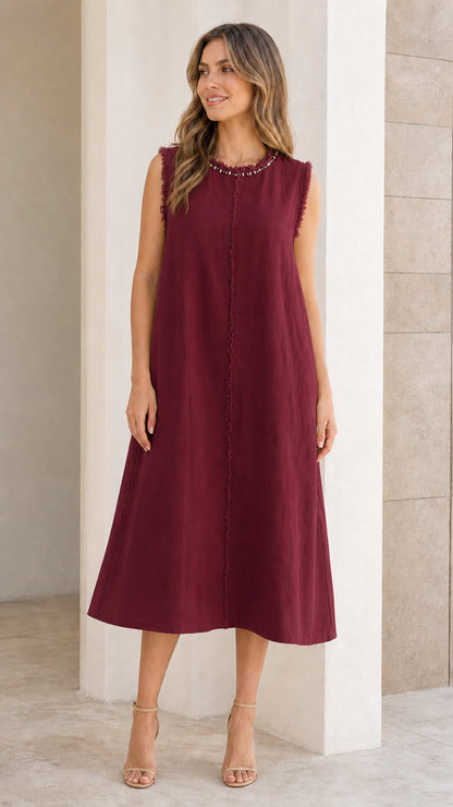 Front view of woman wearing burgundy sleeveless midi dress