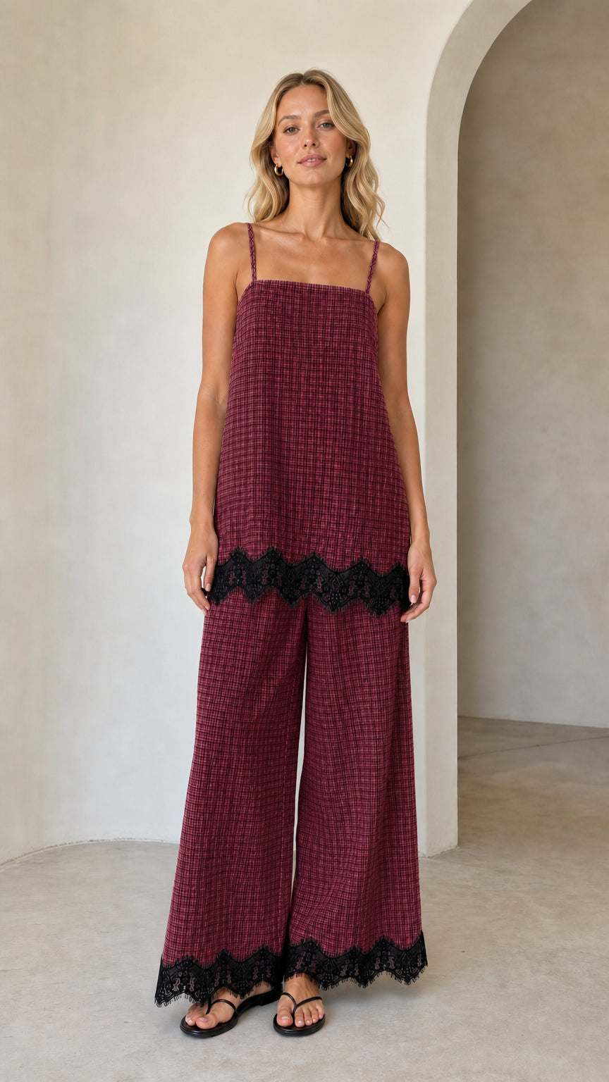 Model wearing burgundy plaid two-piece set with black lace hem