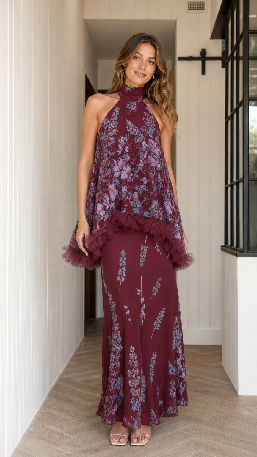 Model wearing burgundy floral halter maxi dress with ruffle overlay