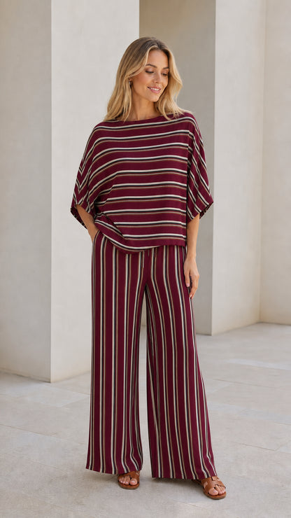 Model wearing burgundy striped top and wide leg pants set