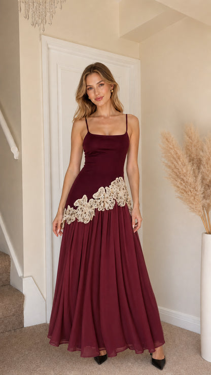 Front view of woman wearing burgundy and beige contrast long slip dress