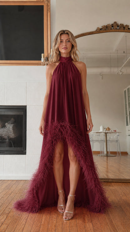 Front view of model wearing burgundy feather hem high neck maxi dress
