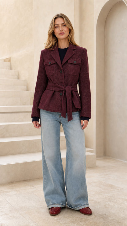 Front view of woman wearing burgundy wine herringbone belted blazer jacket