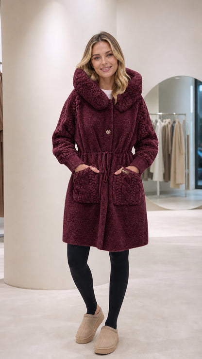 Front full-length view of woman wearing burgundy hooded plush fleece coat