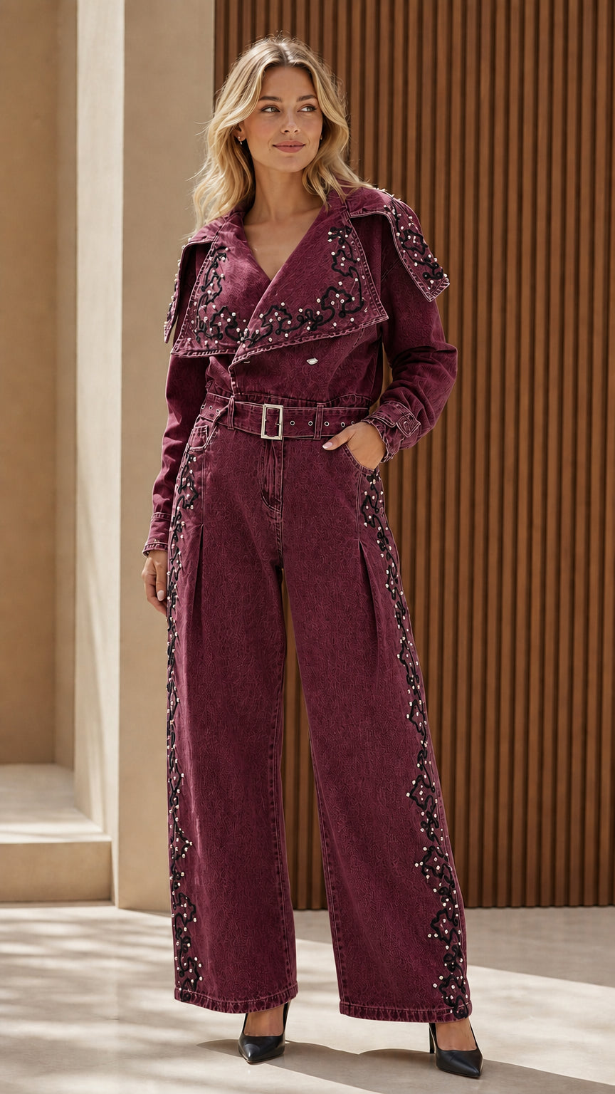 Model wearing burgundy embroidered denim jumpsuit