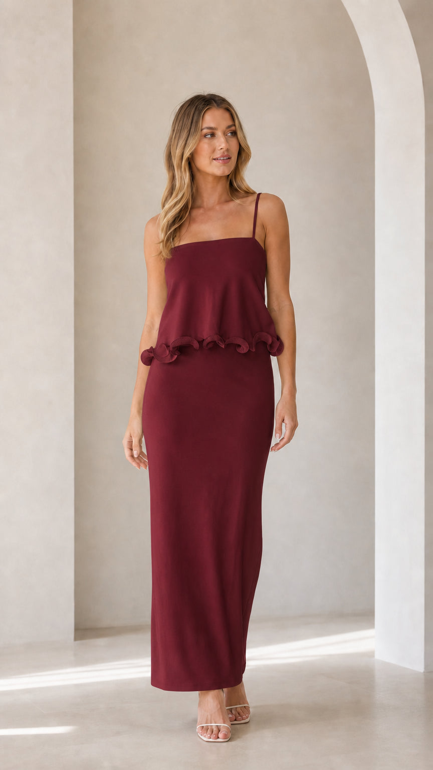 Model wearing burgundy sleeveless ruffle trim maxi camisole dress
