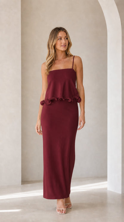 Model wearing burgundy sleeveless ruffle trim maxi camisole dress