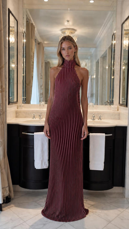 Front view of model wearing burgundy striped halter maxi dress