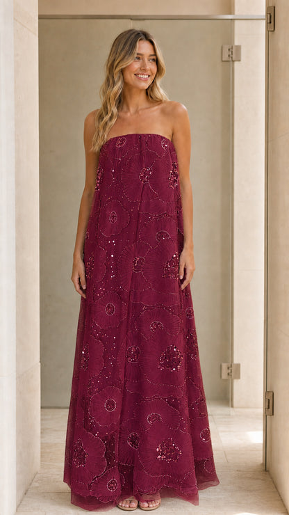 Model wearing burgundy strapless sequin floral maxi dress