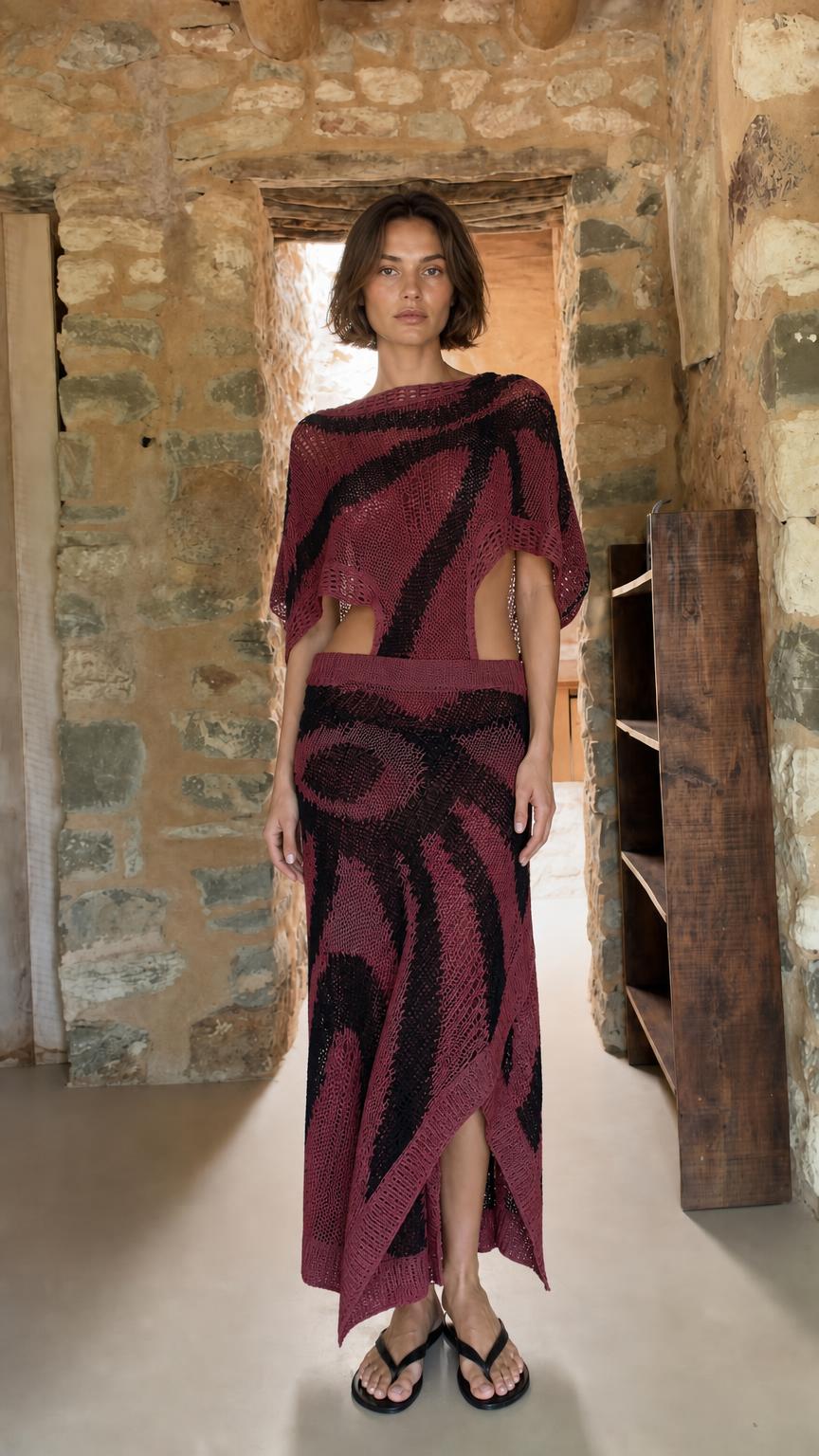 Model wearing burgundy open-knit two-piece maxi set