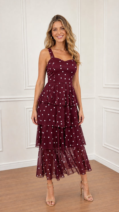 Model wearing Burgundy polka dot tiered midi dress