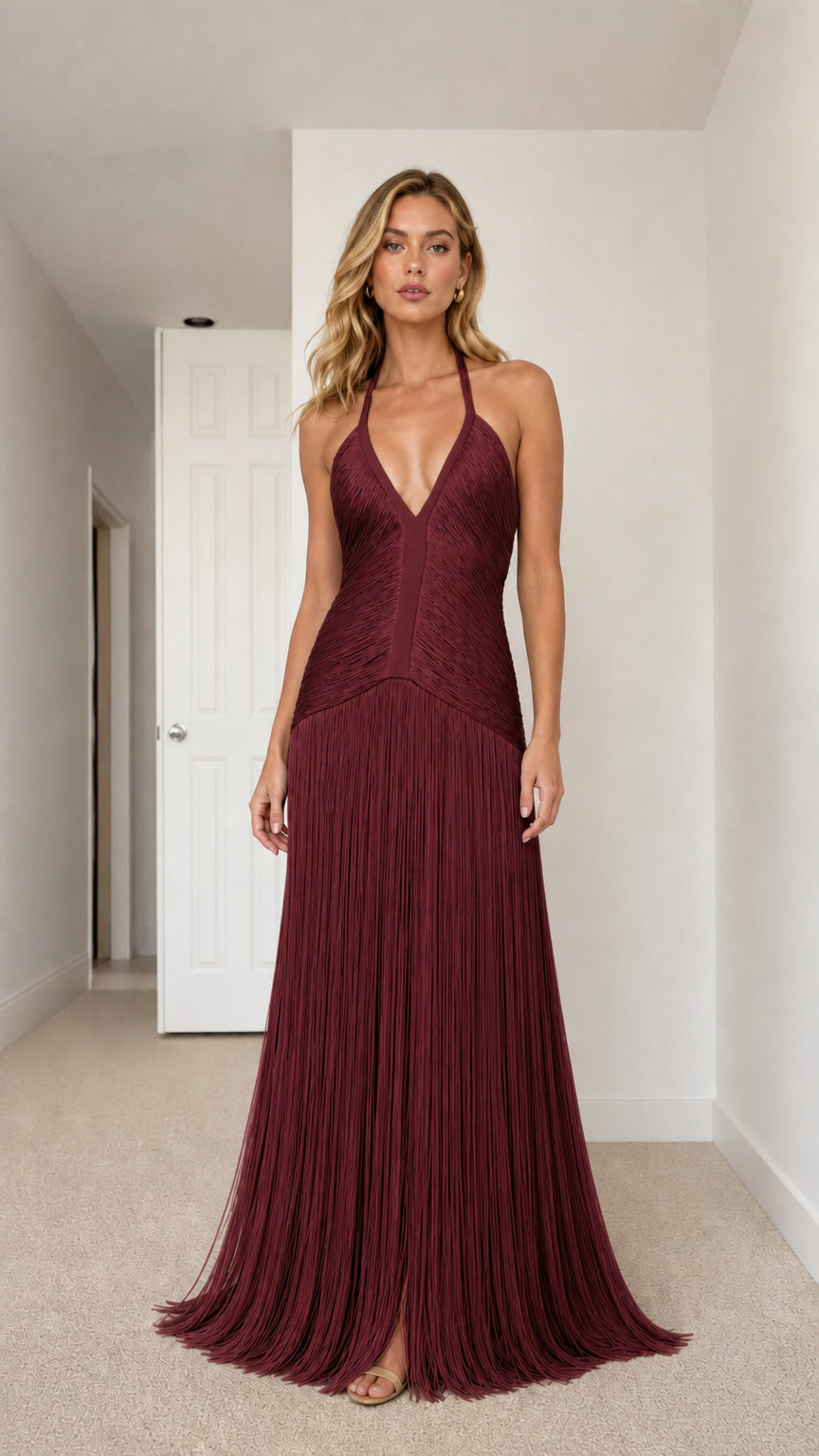 Model wearing rich burgundy halter plunge fringe maxi dress