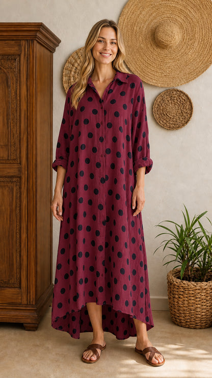 Front view of burgundy polka dot maxi shirt dress on model