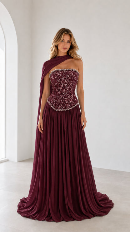 Full front view of burgundy one-shoulder beaded corset evening gown
