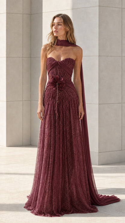 Front view of burgundy strapless lace evening gown with draped scarf