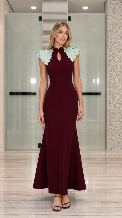 Full-length view of burgundy red mermaid evening gown with contrast mint petal shoulders