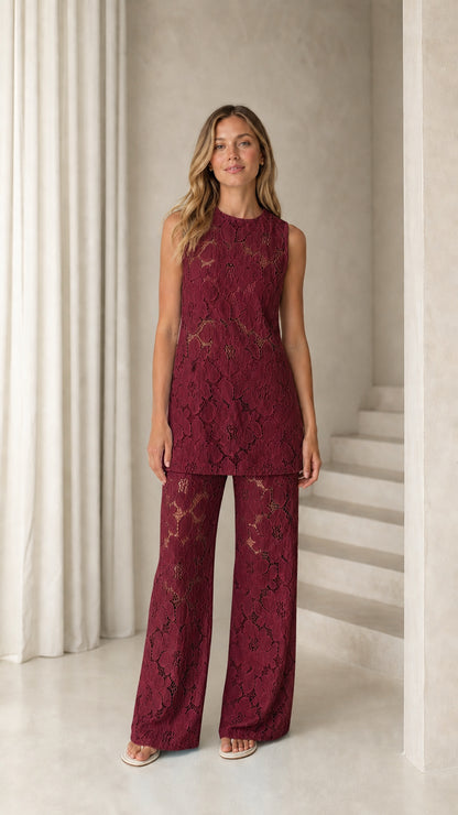Woman wearing burgundy floral lace sleeveless top and wide leg pants set