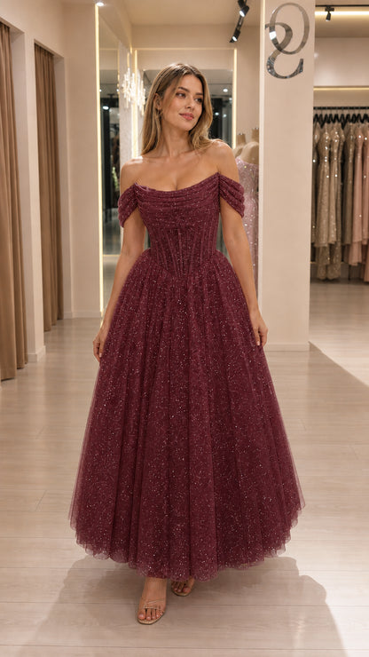 Model wearing burgundy glitter tulle corset midi dress