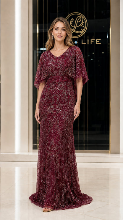 Front view of woman wearing burgundy beaded evening gown