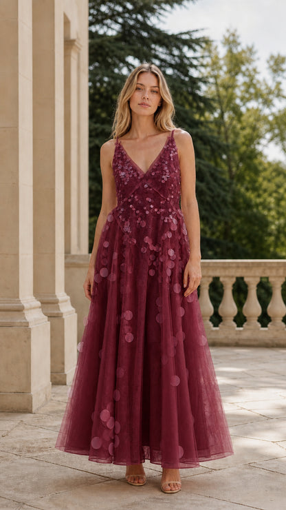 Full length view of woman in burgundy sequin tulle maxi dress