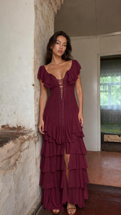 Front view of model wearing burgundy ruffle tiered maxi dress