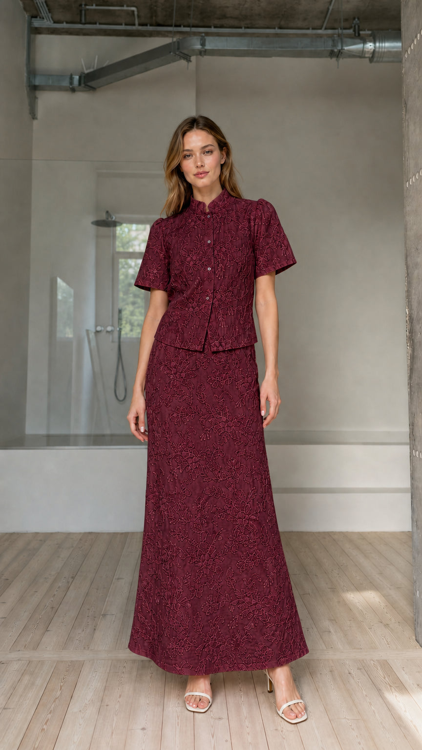 Model wearing burgundy floral embroidered short-sleeve top and maxi skirt matching set