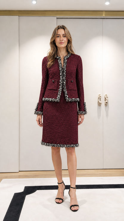 Model wearing burgundy tweed jacket and skirt set
