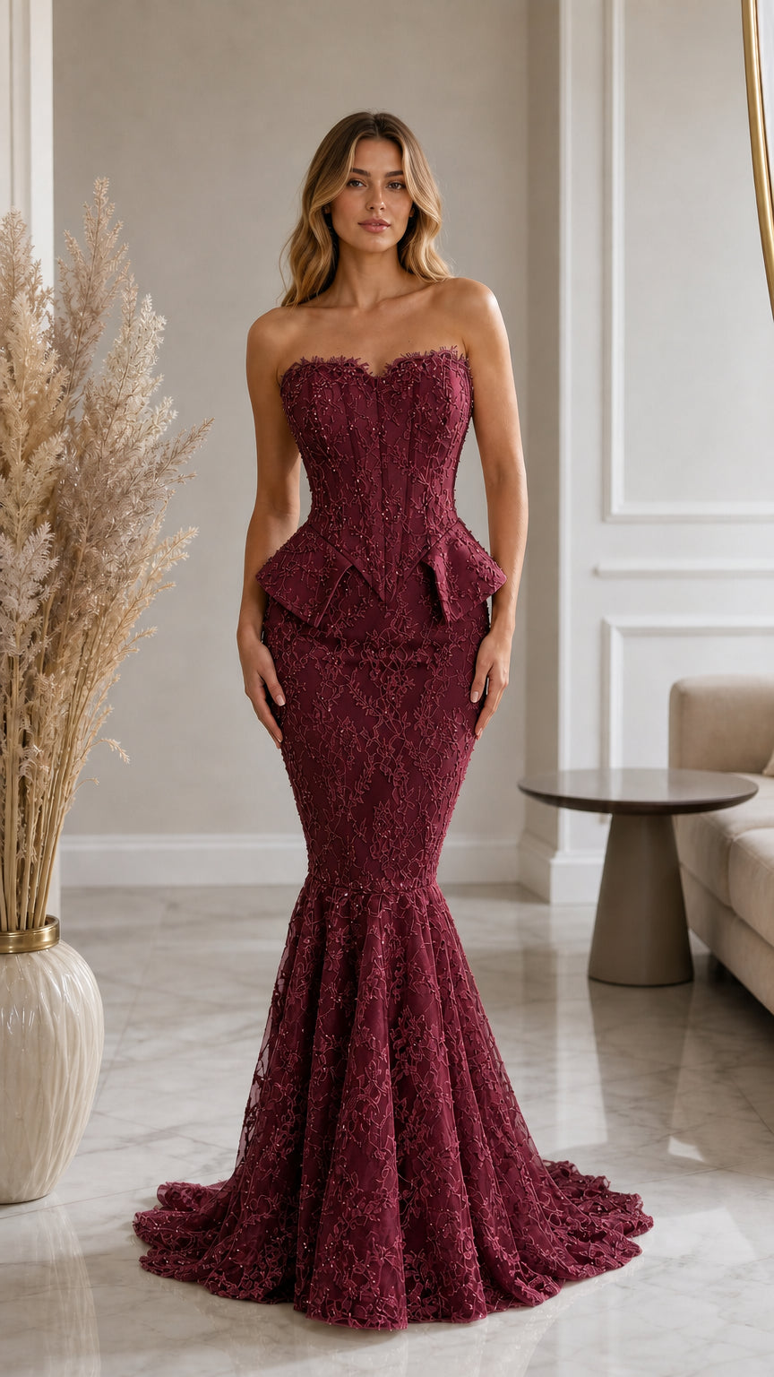 Front view of model wearing burgundy wine strapless lace corset mermaid evening gown