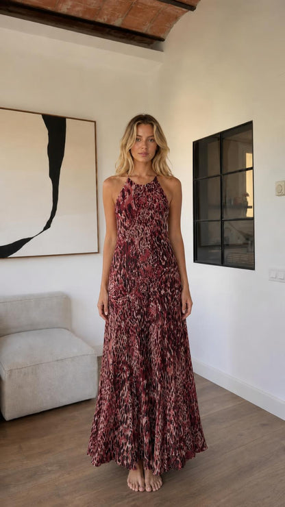 Front view of woman wearing burgundy animal print maxi dress
