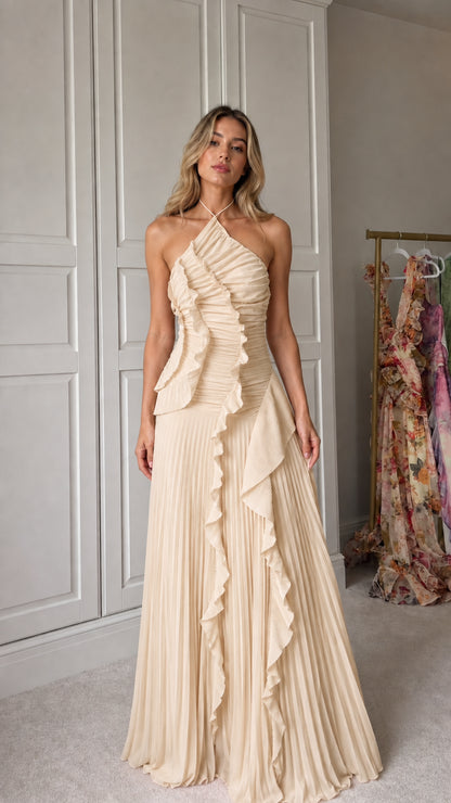 Front view of model wearing champagne halter neck pleated ruffle maxi dress