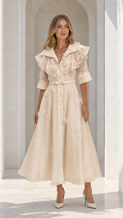 Model wearing champagne floral applique ruffle midi dress