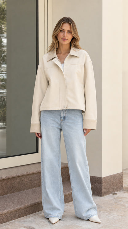 Model wearing cream beige cropped utility jacket with light wash jeans
