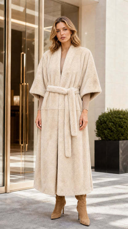 Front view of woman wearing long off-white faux fur coat