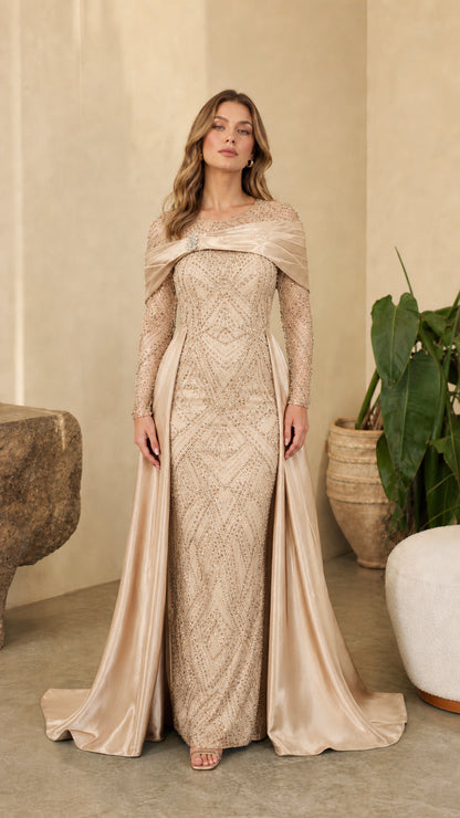 Full front view of model wearing Champagne gold sequin evening dress with matching satin overskirt