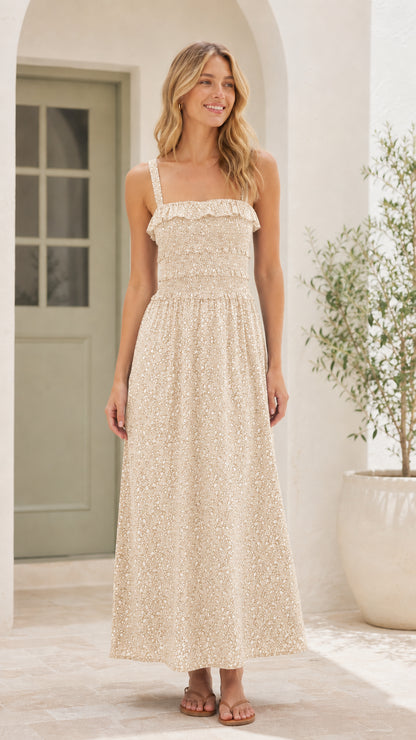 Front view of woman wearing beige floral smocked midi dress