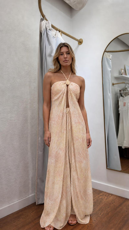 Model wearing beige patterned halter maxi dress