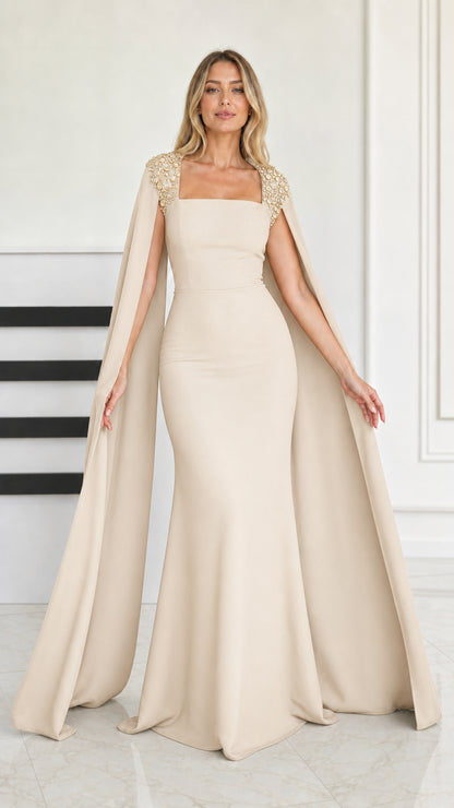 Front view of champagne beige cape sleeve mermaid evening gown