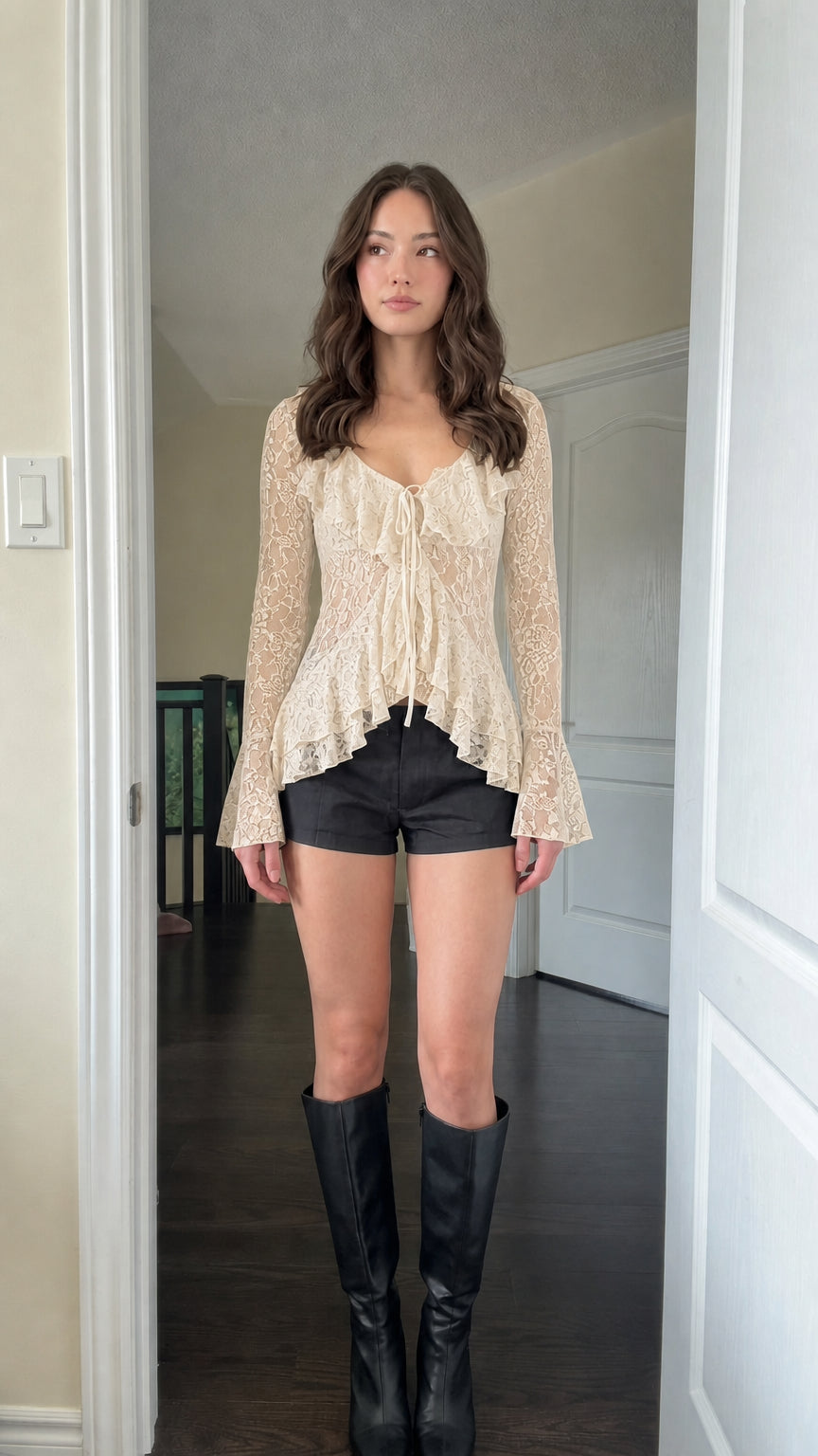 Model wearing Beige sheer lace ruffle tie-front blouse