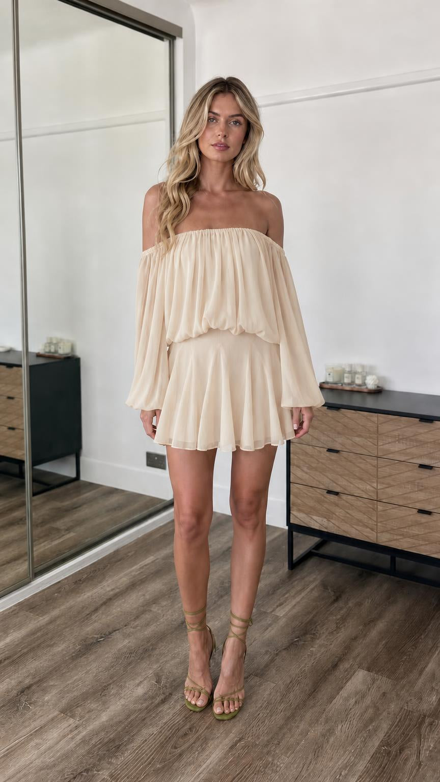 Front view of model wearing champagne off-the-shoulder mini dress