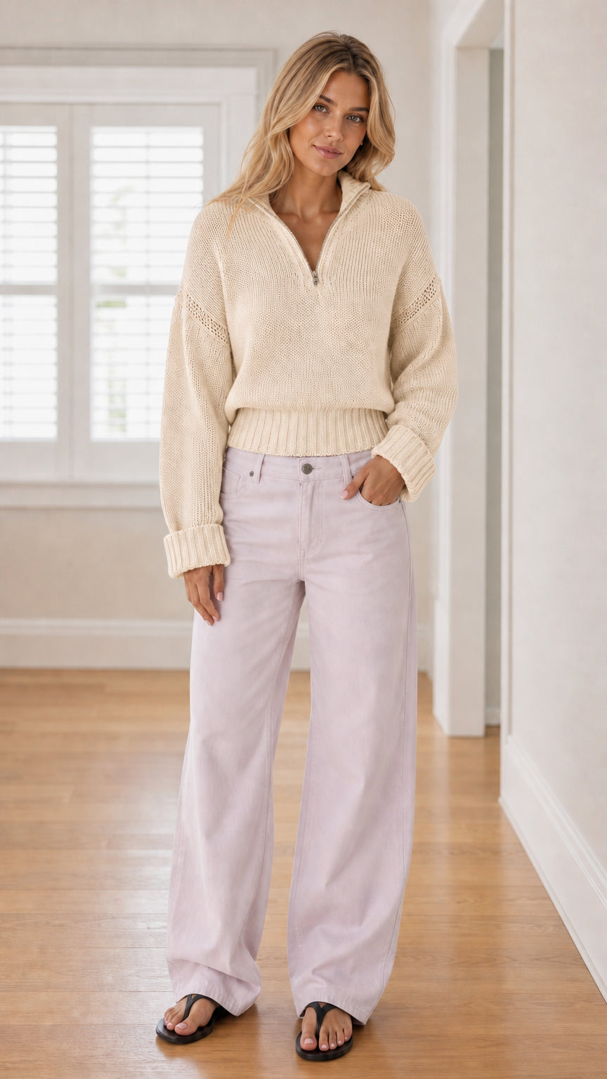 Model wearing cream off-white half-zip knit sweater