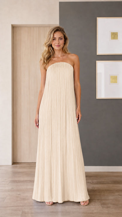 Model wearing champagne strapless pleated maxi dress