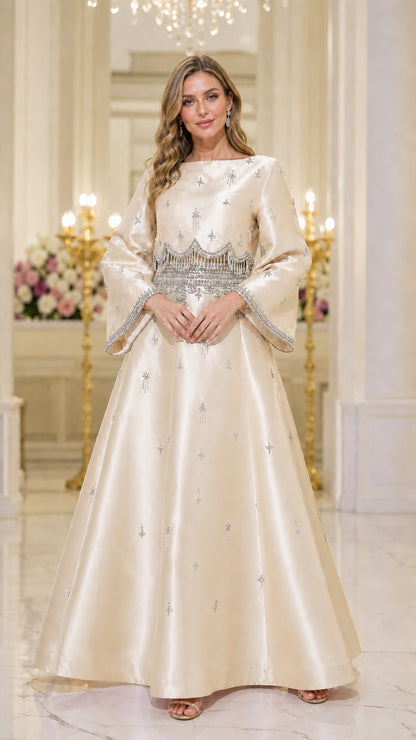 Front view of model wearing champagne beaded maxi dress