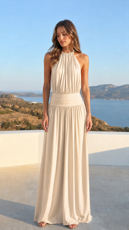 Woman wearing a champagne cream halter neck backless evening maxi dress