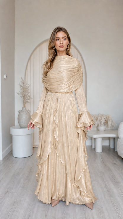Front view of model wearing metallic champagne pleated long sleeve maxi dress