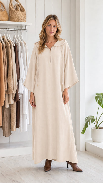 Full view of woman wearing beige hooded maxi kaftan